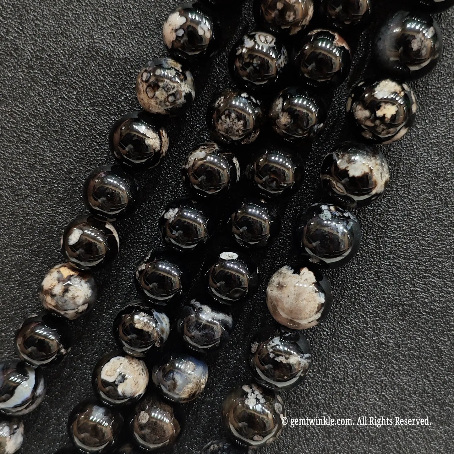 Three parallel wholesale strands of dyed black flower agate crystal beads with a natural chalcedony base to verify pattern distribution