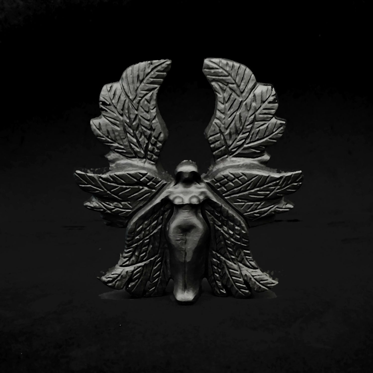 Front view of a 10cm hand carved black obsidian Seraphim statue showcasing symmetrical six layered wings