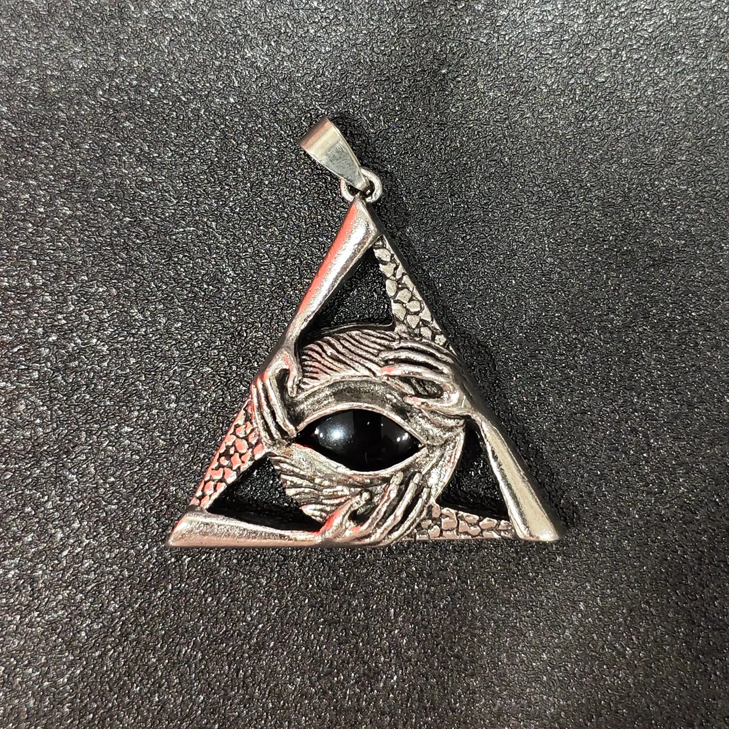 Black obsidian round cabochon set in antique silver triangle metal frame with eye motif