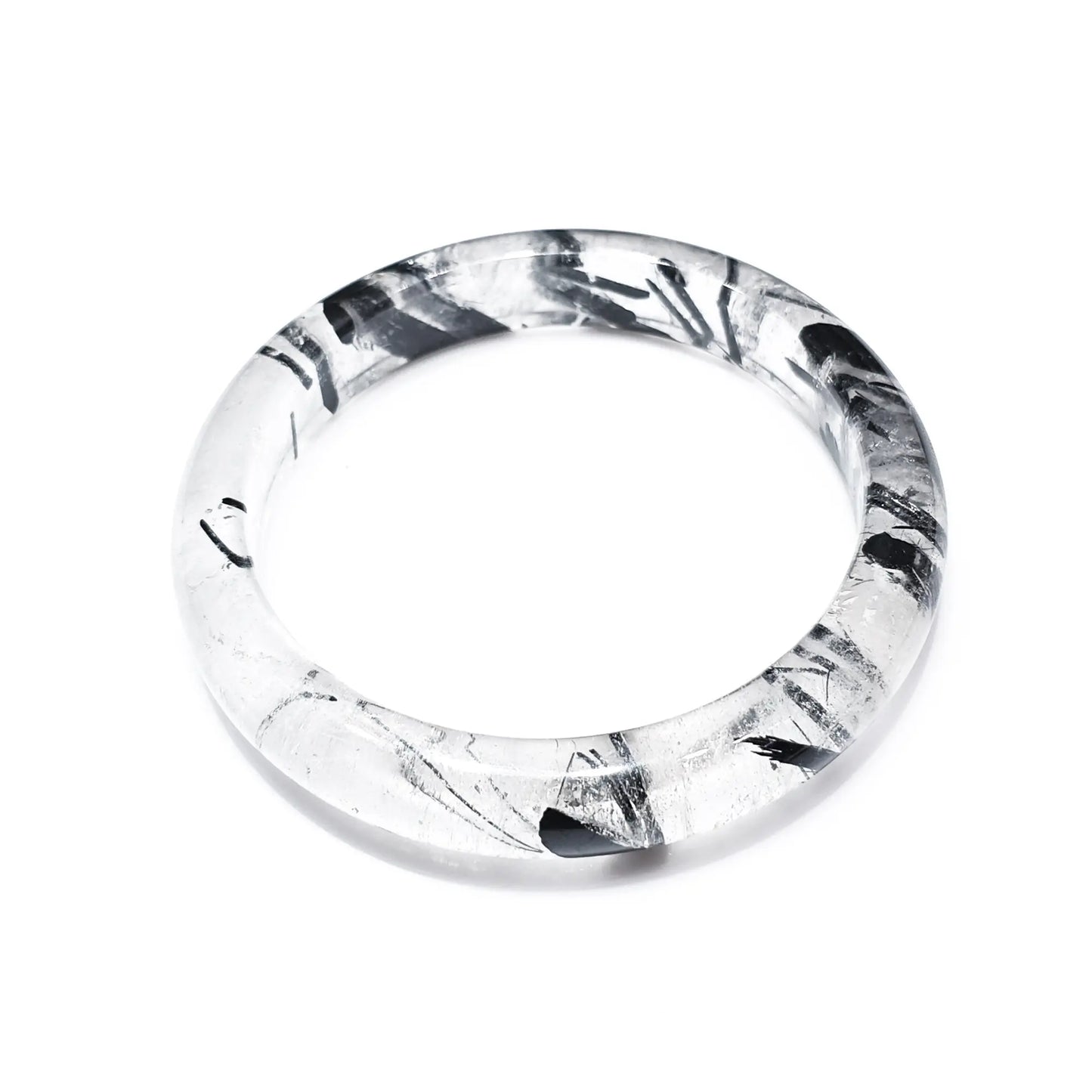 Natural black rutilated quartz bangle with black tourmaline inclusions on white background