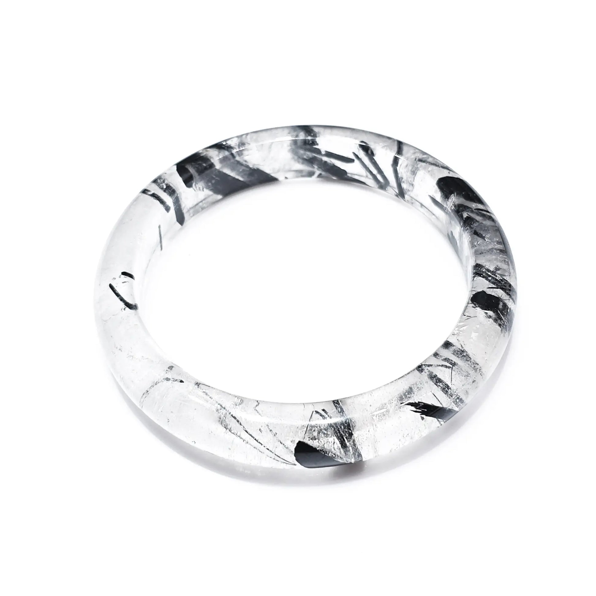 Natural black rutilated quartz bangle with black tourmaline inclusions on white background