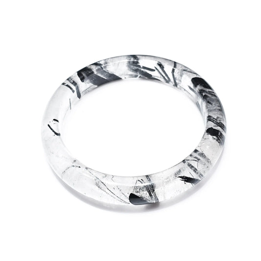 Natural black rutilated quartz bangle with black tourmaline inclusions on white background