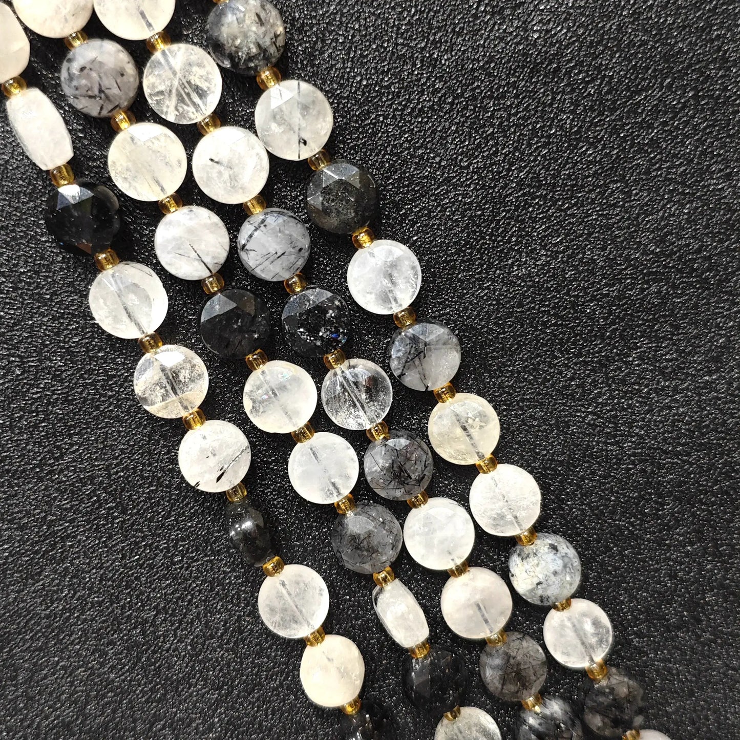 Strands of natural black rutilated quartz faceted coin beads in flat disc shape