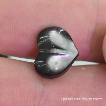 Black MOP puffy heart bead top angle view showing vertical top to bottom straight drill hole