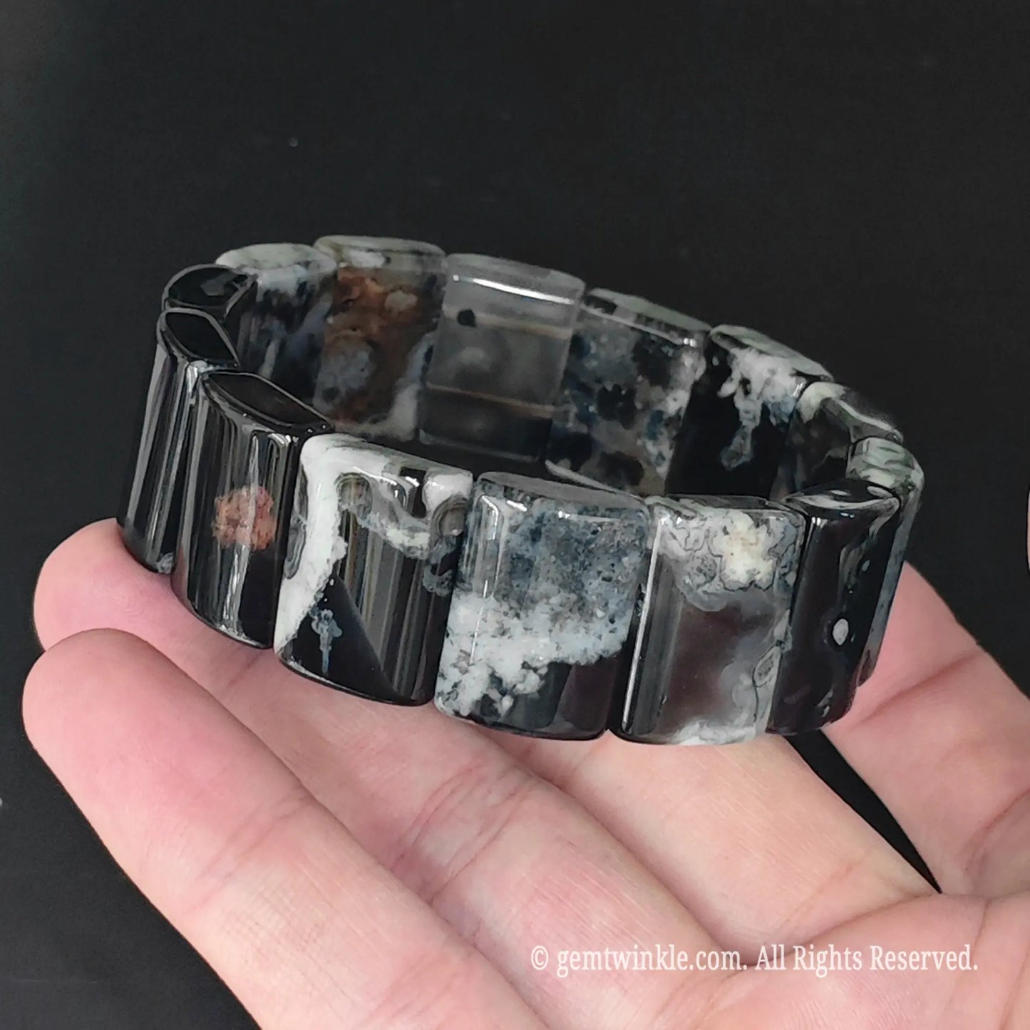 Side view of black blossom agate 20x15mm curved plate cuff bracelet showing polished plate thickness