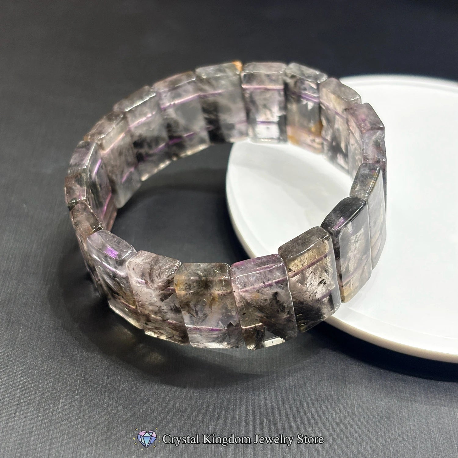 black dream phantom quartz rectangular slab bracelets crossed on white disc
