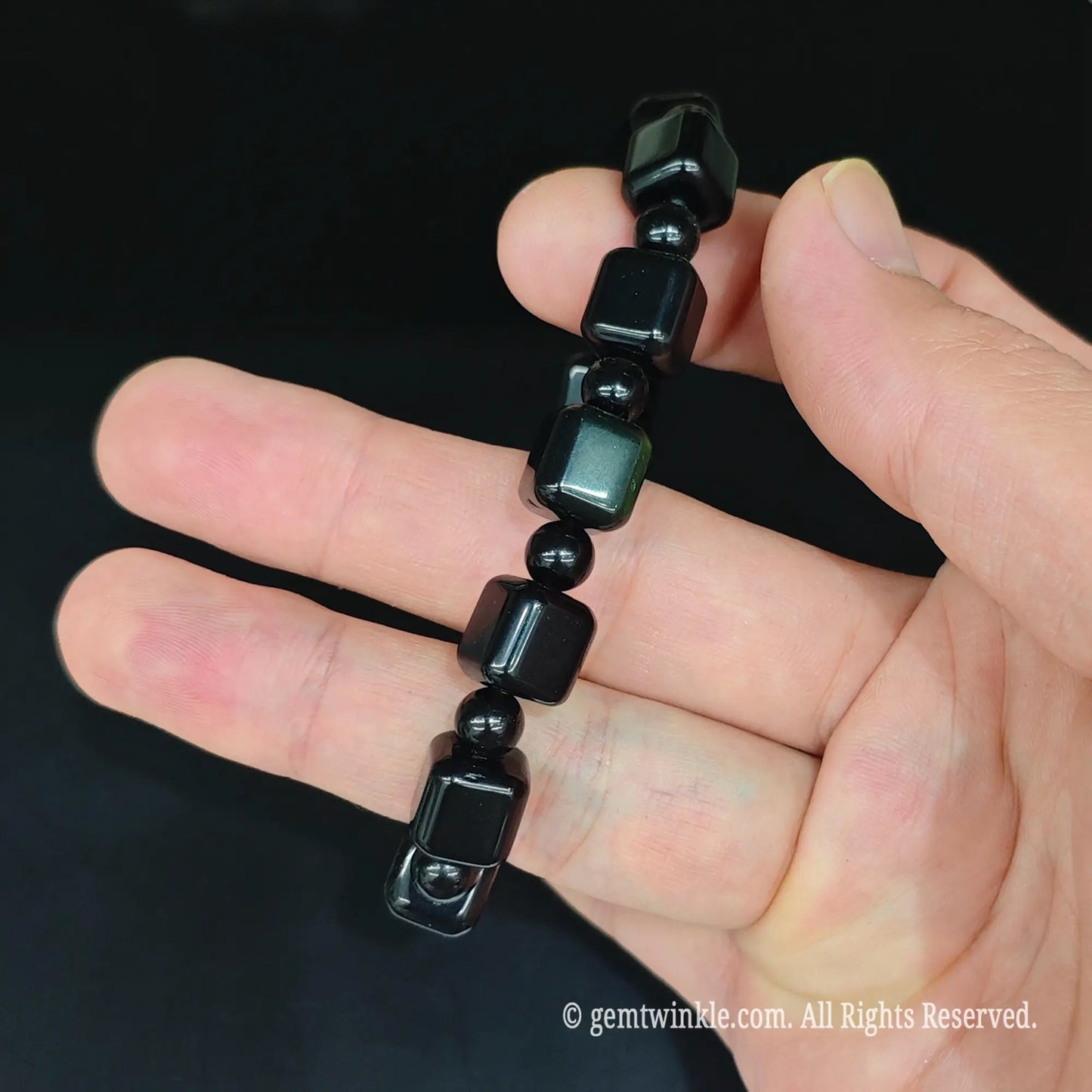 Black obsidian geometric cube stretch bracelet side view displaying alternating cube and spacer bead arrangement