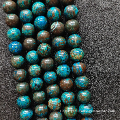 Perspective view of blue chrysocolla round beads showing polished finish across 4mm to 10mm sizes