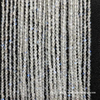 Perspective view of 2mm blue flash moonstone round seed beads displaying micro polished finish