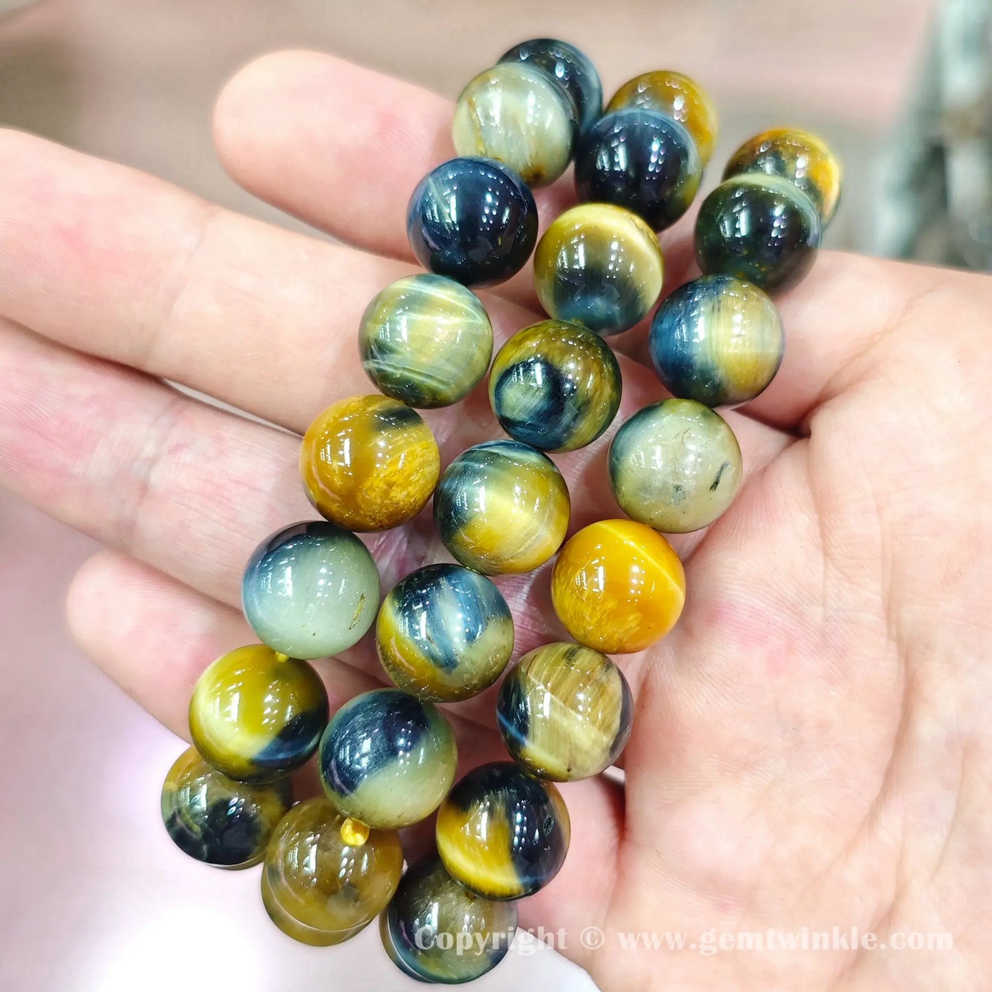 Close up view of smooth round tiger eye beads highlighting natural silky chatoyancy sheen
