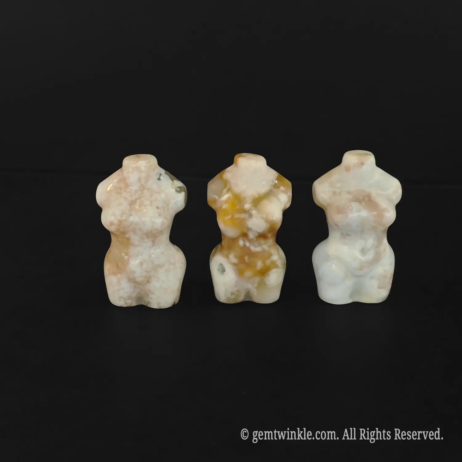 Three 5cm cherry blossom agate female body carvings lined up cleanly showcasing distinct chalcedony inclusions