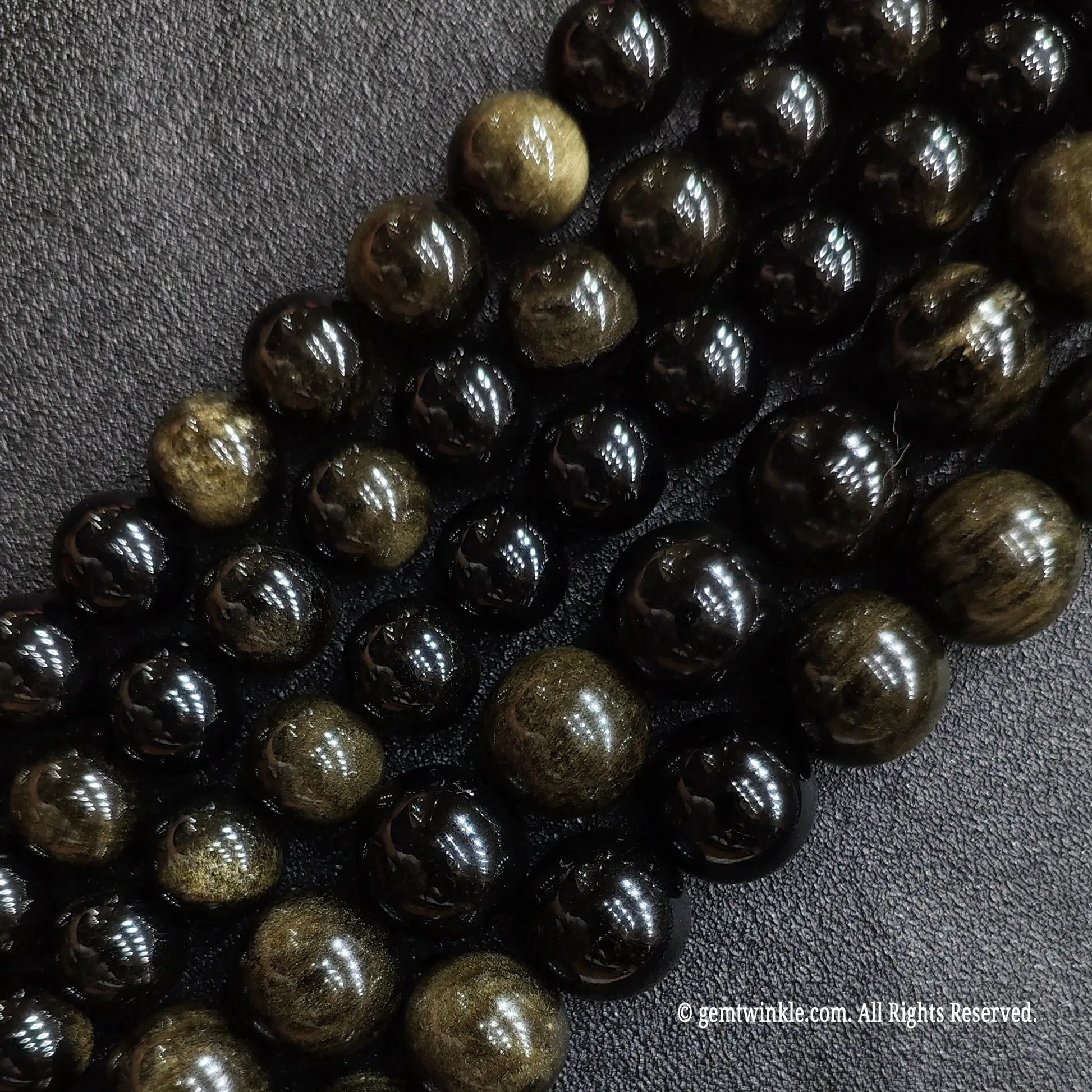 Multiple strands of natural c grade gold sheen obsidian beads showing diverse size choice variations