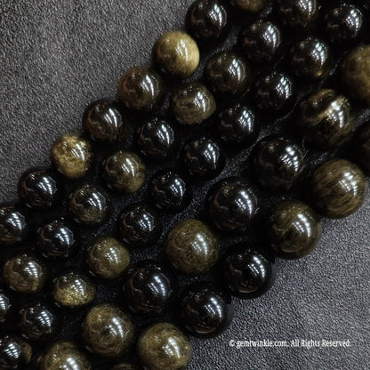 Multiple strands of natural c grade gold sheen obsidian beads showing diverse size choice variations