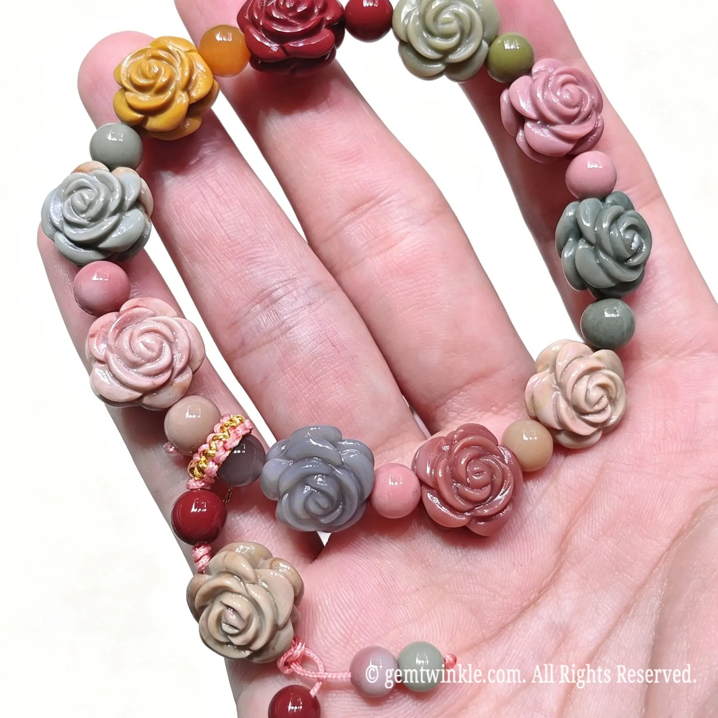 Close up preview of carved Ala Shan Gobi agate rose beads and decorative cord knotting