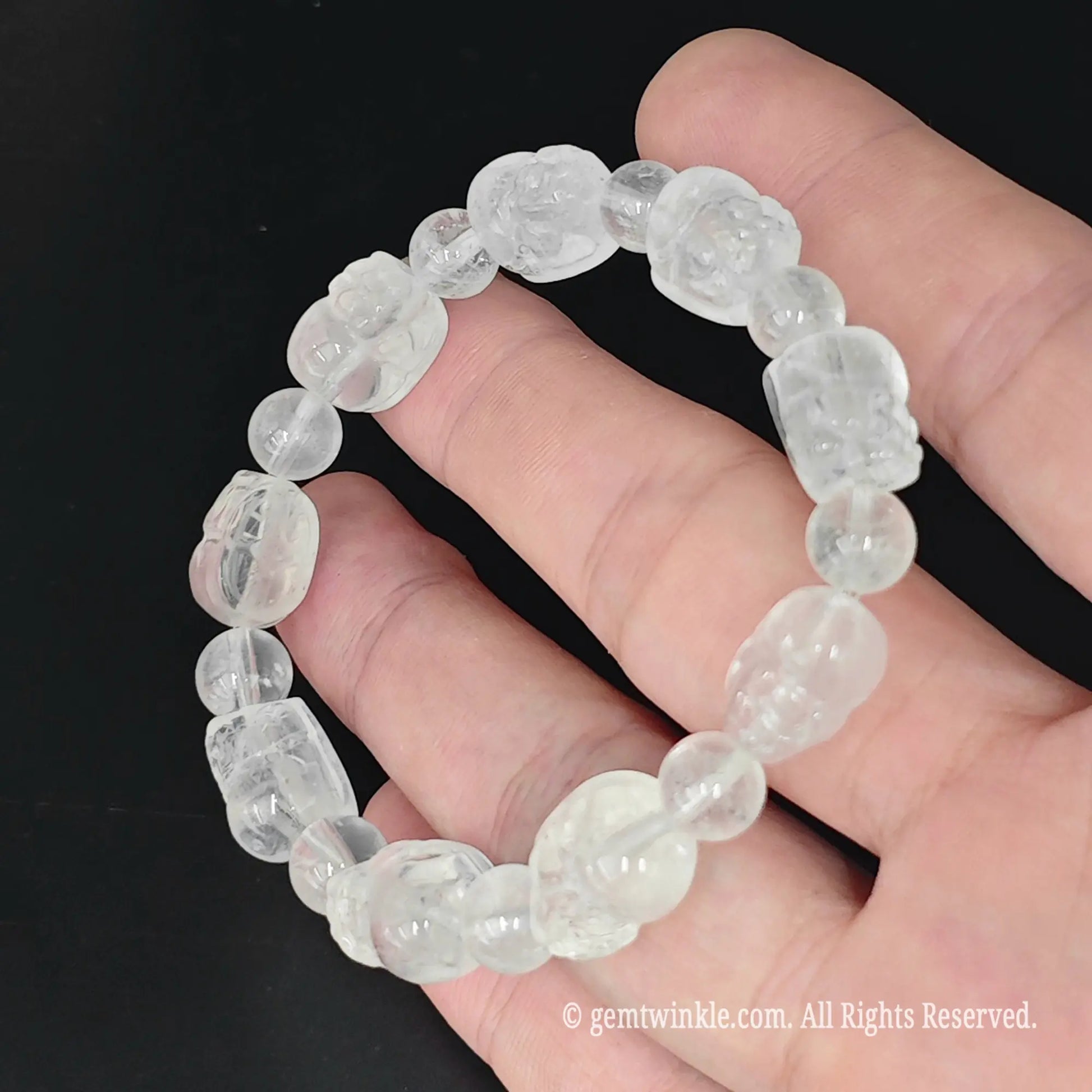 12mm carved cloudy quartz pixiu stretch bracelet with natural frost inclusions displayed in open hand