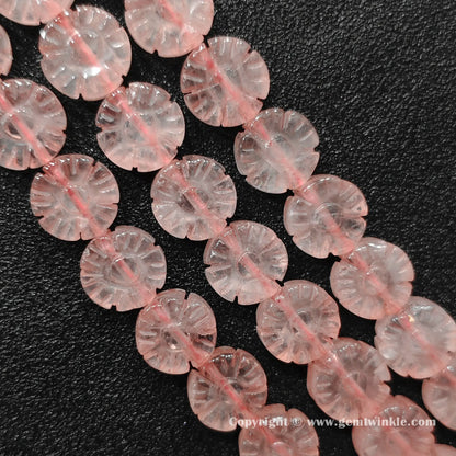 Natural rose quartz plum blossom flower bead strands laid on surface for quality preview
