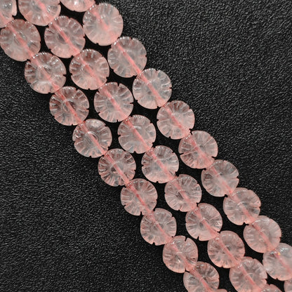 Macro closeup of carved natural rose quartz plum blossom flower beads showing smooth polish