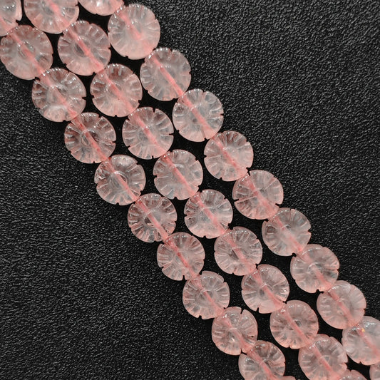 Macro closeup of carved natural rose quartz plum blossom flower beads showing smooth polish