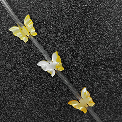 carved butterfly yellow mother of pearl beads strand view