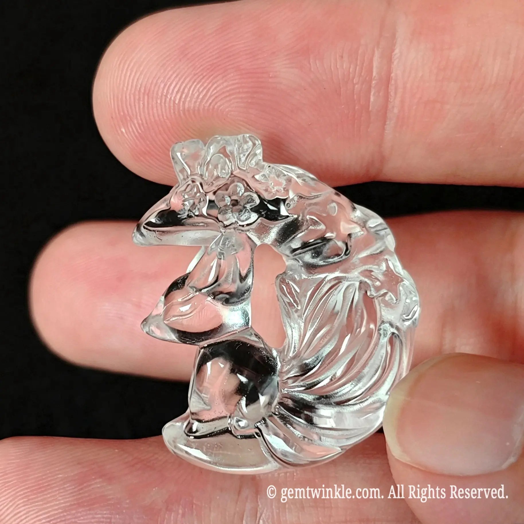 Back view of carved clear quartz fox on moon pendant showing transparent glass-like texture and smooth polish