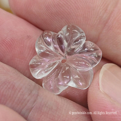 Carved quartz flower focal bead close up view showing light refraction and smooth carved petal contours