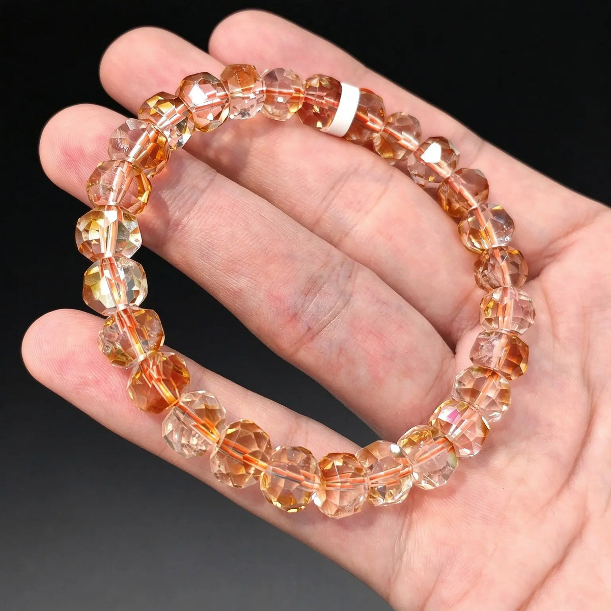 Light champagne citrine quartz bracelet with tower cut pagoda faceted beads displayed on a hand