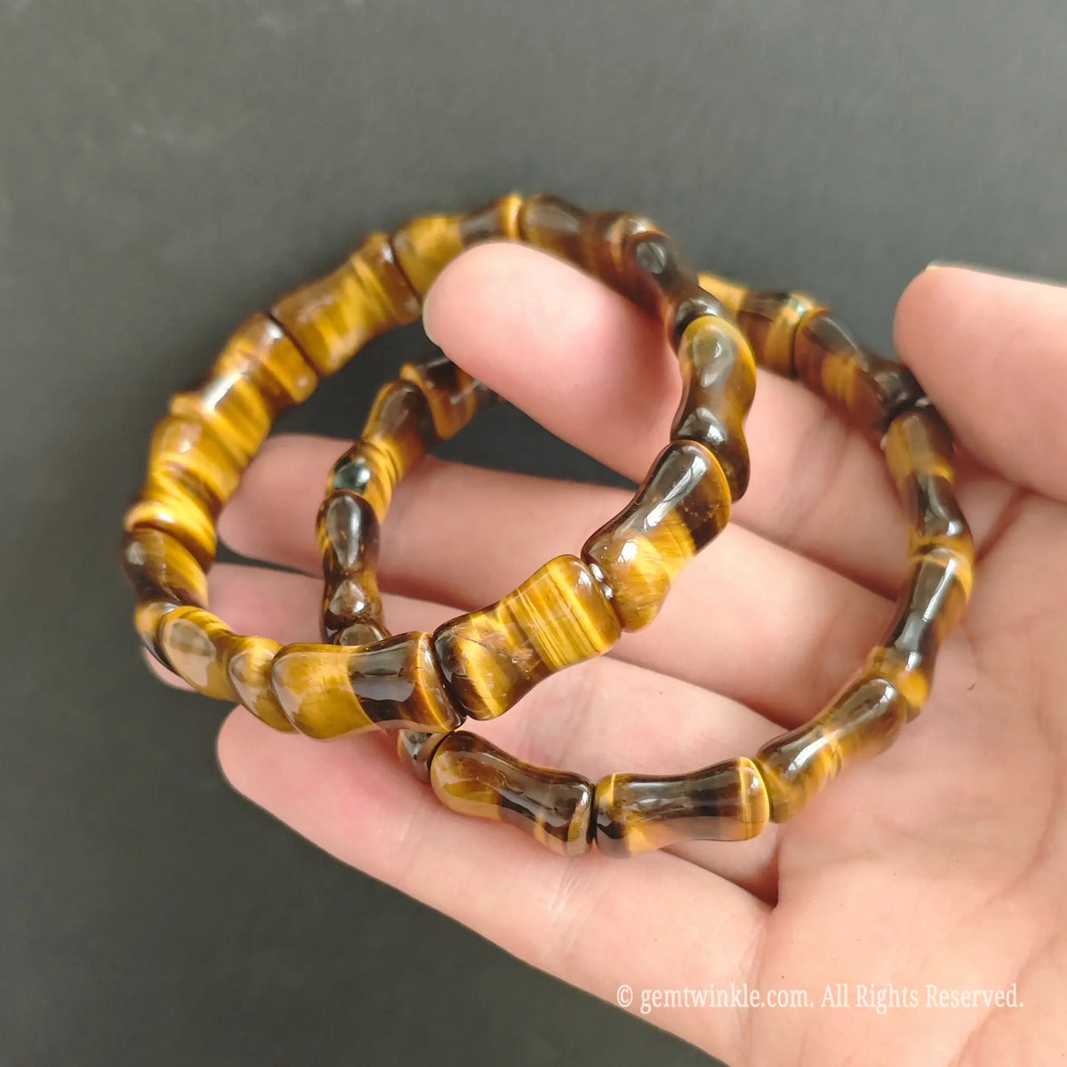 Natural Tiger Eye carved tube bracelets held together demonstrating golden flash and high gloss finish