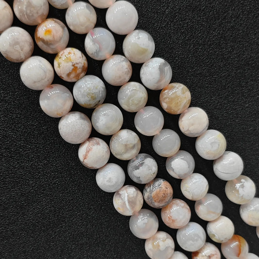 Close up view of genuine cherry blossom agate smooth round beads strands highlighting natural pink and white floral plumes in image_bdfdc7.jpg