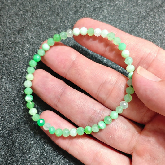 4mm Australian chrysoprase faceted mini bead stretch bracelet held in hand showing translucent apple green color