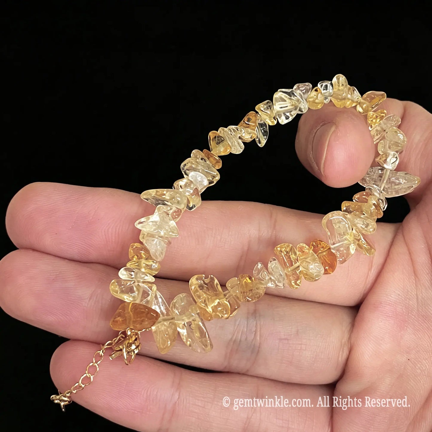 detail view of lobster clasp and gold tone extender chain on citrine bracelet
