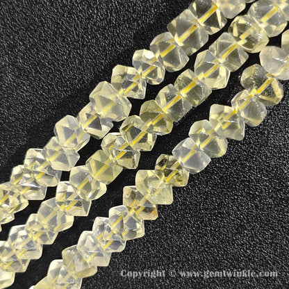 Close up view of faceted citron yellow quartz tube cylinder beads showing clear transparency