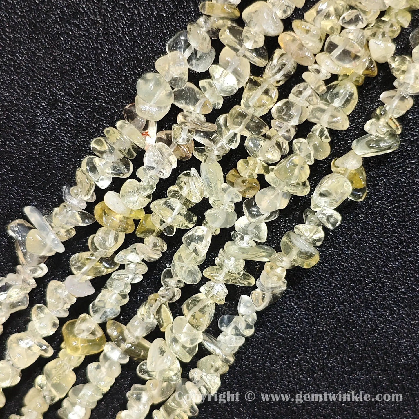 Close up view of tumbled citron yellow quartz freeform nugget chip beads