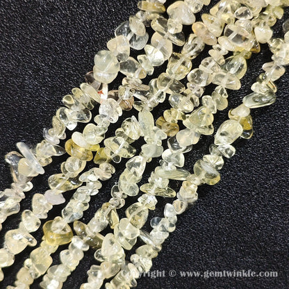 Close up view of tumbled citron yellow quartz freeform nugget chip beads