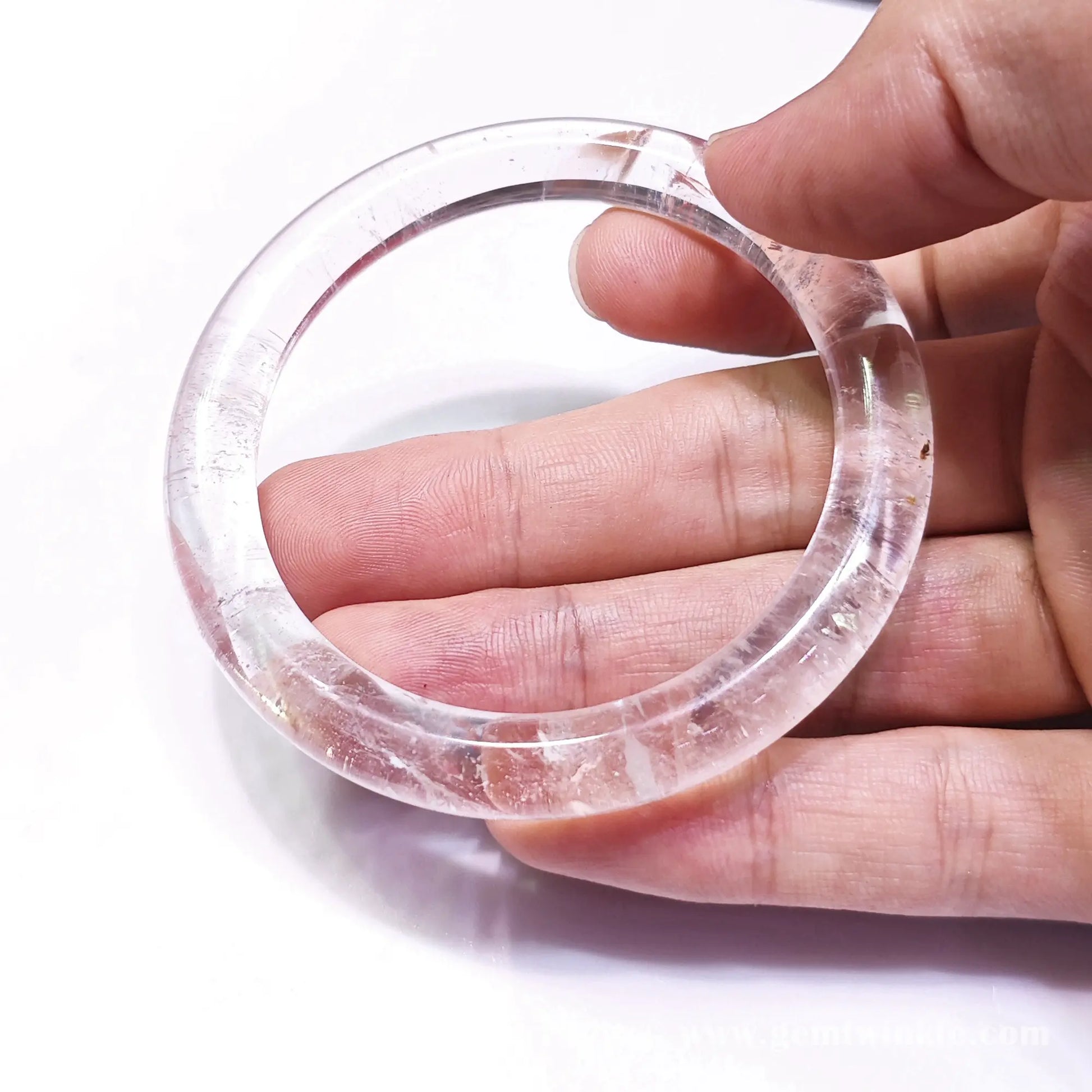 Handheld front perspective highlighting 56mm 62mm size proportion and polished quartz ring structure