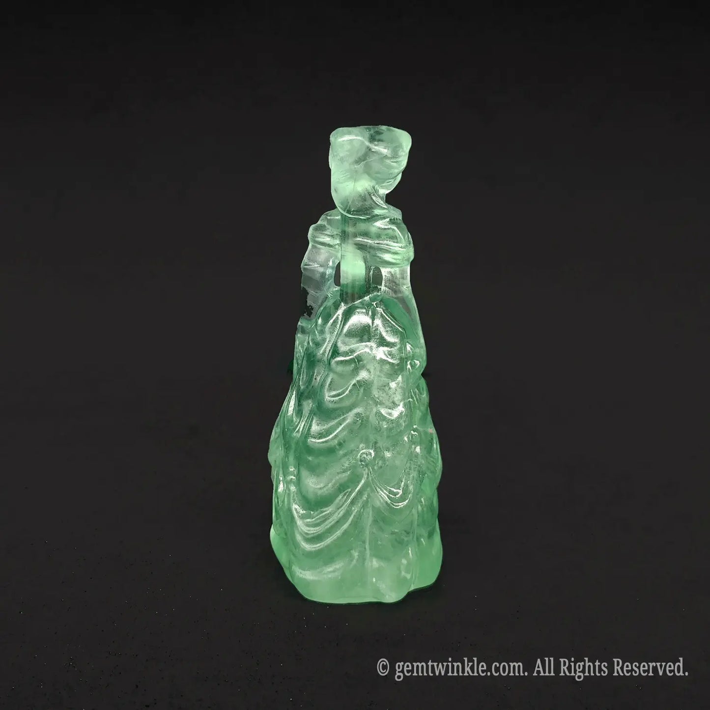Back view of a premium natural green crystal princess statue with smooth polished wings and dress lines, ideal for sage green and cottagecore decor