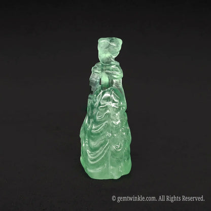 Back view of a premium natural green crystal princess statue with smooth polished wings and dress lines, ideal for sage green and cottagecore decor