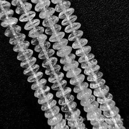 Natural clear quartz rondelle bead strand held over hand showing size scale