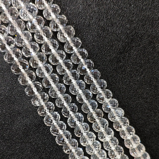 Macro closeup of Grade-A clear quartz faceted rondelle beads showing light refraction and clear body