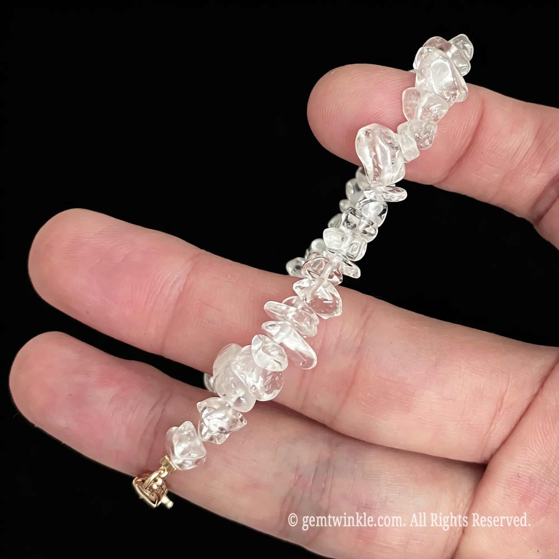 side view of clear quartz nugget bracelet showing natural icy fractures and cloudy inclusions