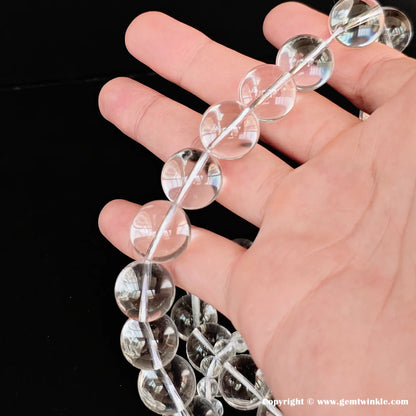 Water-clear rock crystal loose bead strands in palm, premium micro-wholesale gemstone supplies for boutique designers