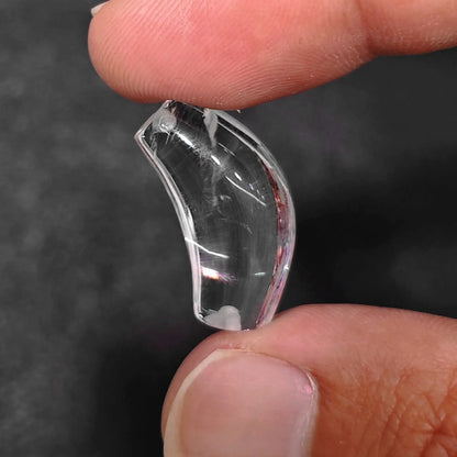 clear quartz curved tube bead with nape drilled hole held between fingers