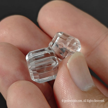 Clear quartz cut corner cube beads pair showing straight center drill hole for jewelry wire stringing