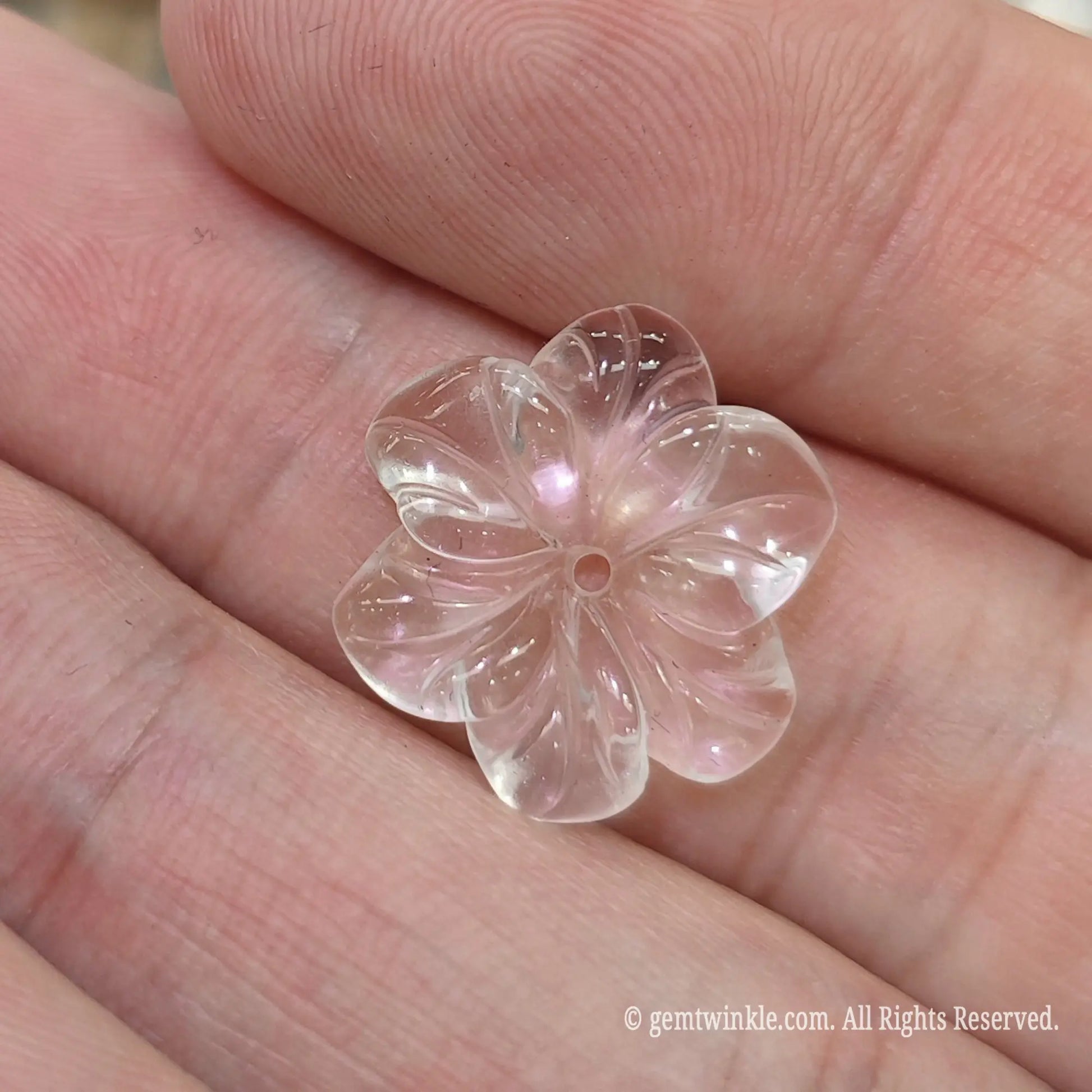 Clear quartz flower spacer bead for diy jewelry making displaying ice clean transparency on palm