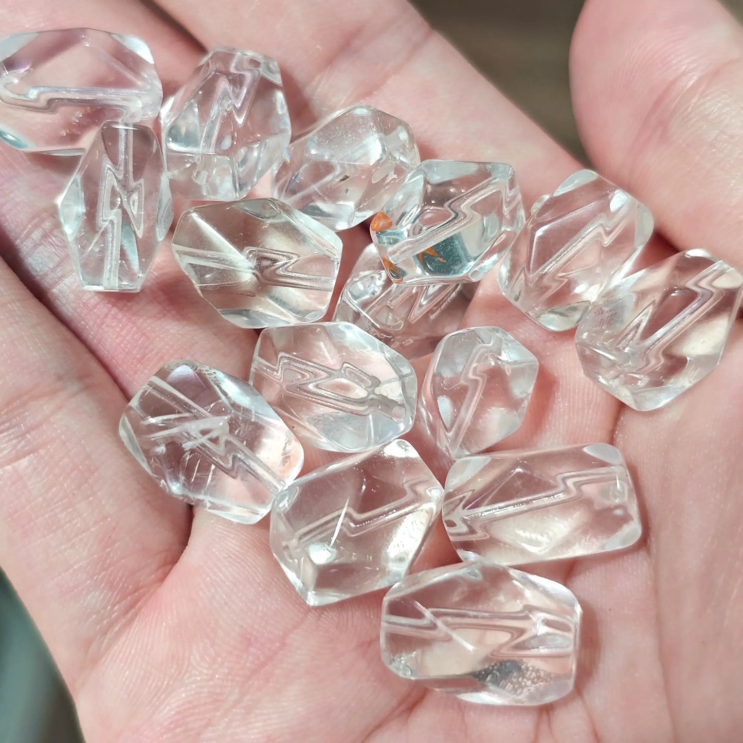 Scattered clear quartz freeform nugget beads held in hand for DIY jewelry making and wire wrapping