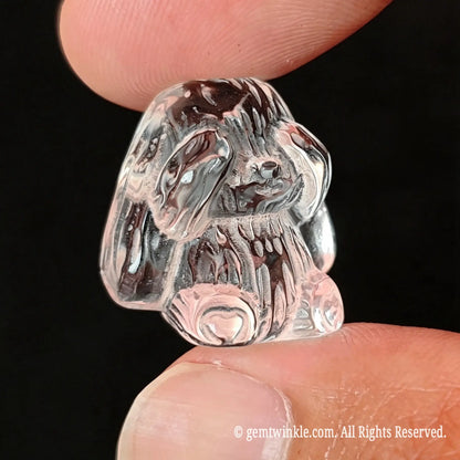 Close up side view of translucent clear quartz rabbit carving showing light refraction and detailed ear relief