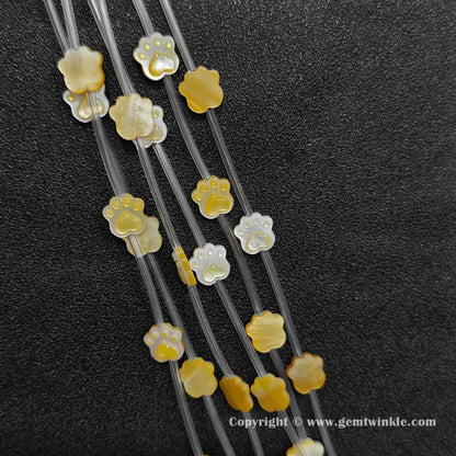 close-up-gold-lip-shell-machine-carved-paw-charms