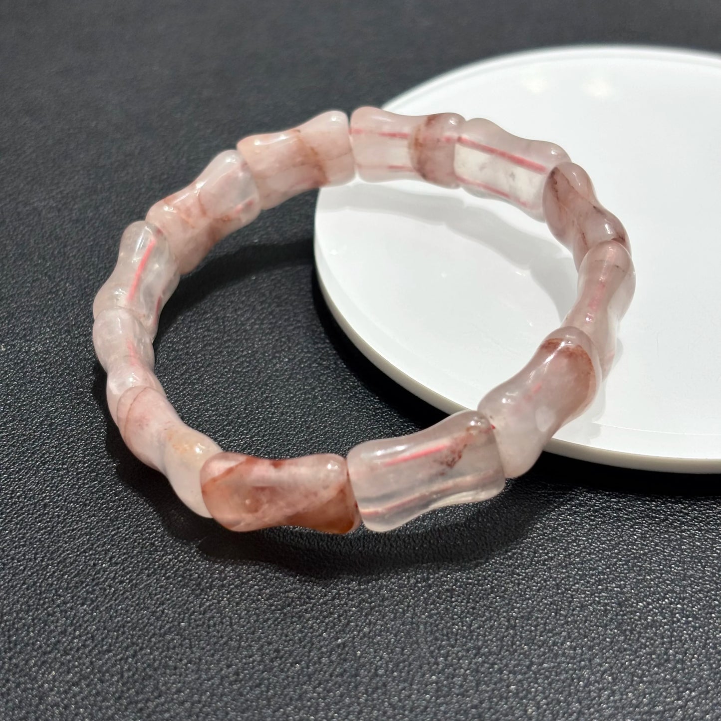 Close up of red phantom quartz bamboo beads showing natural inclusions.
