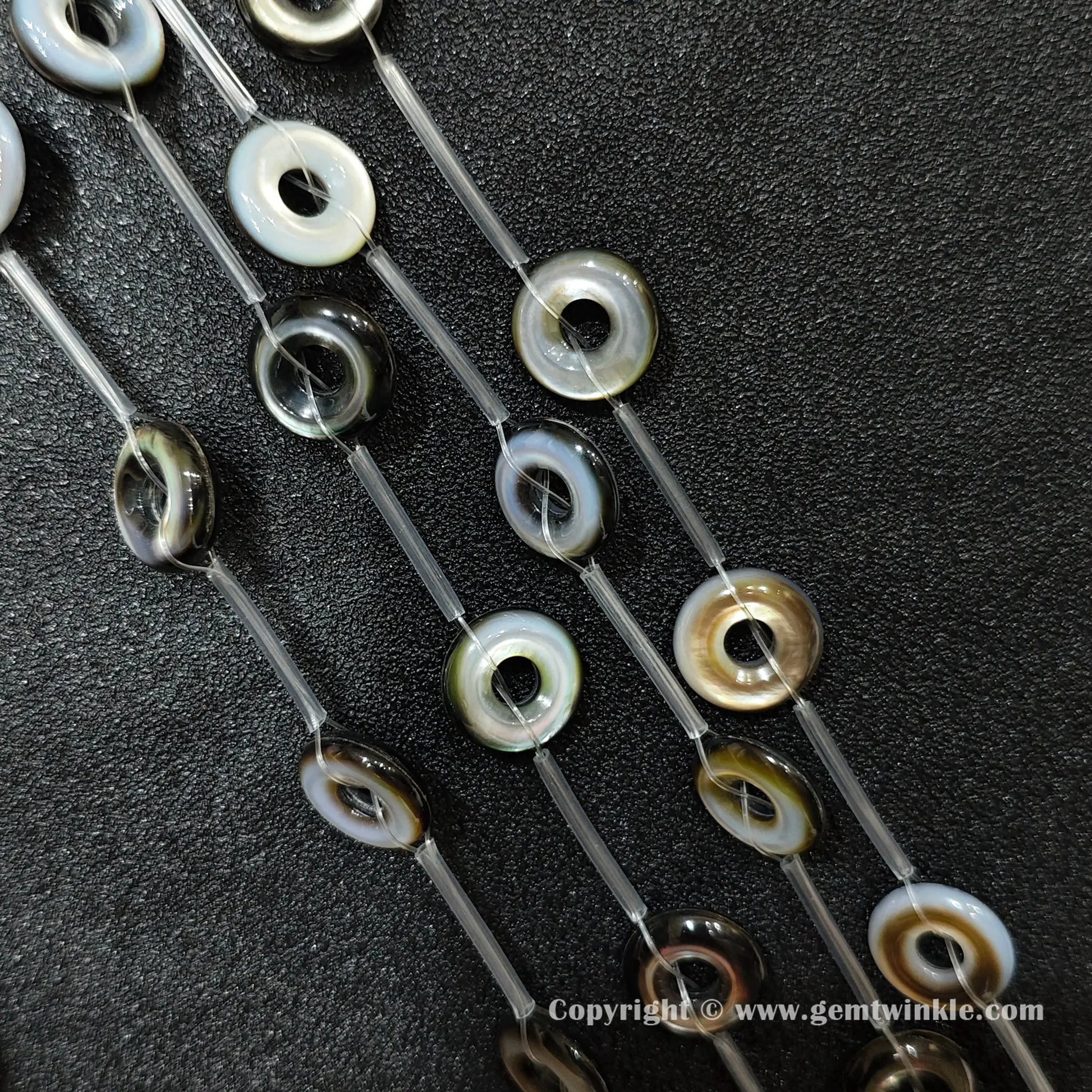 close up of double layered mother of pearl round ring charms