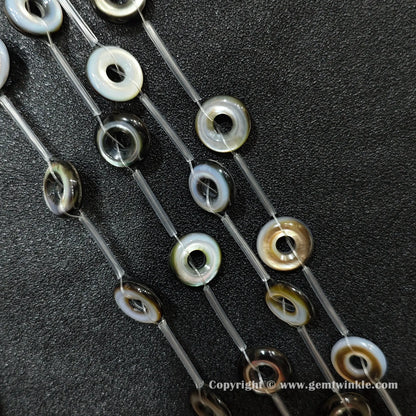 close up of double layered mother of pearl round ring charms