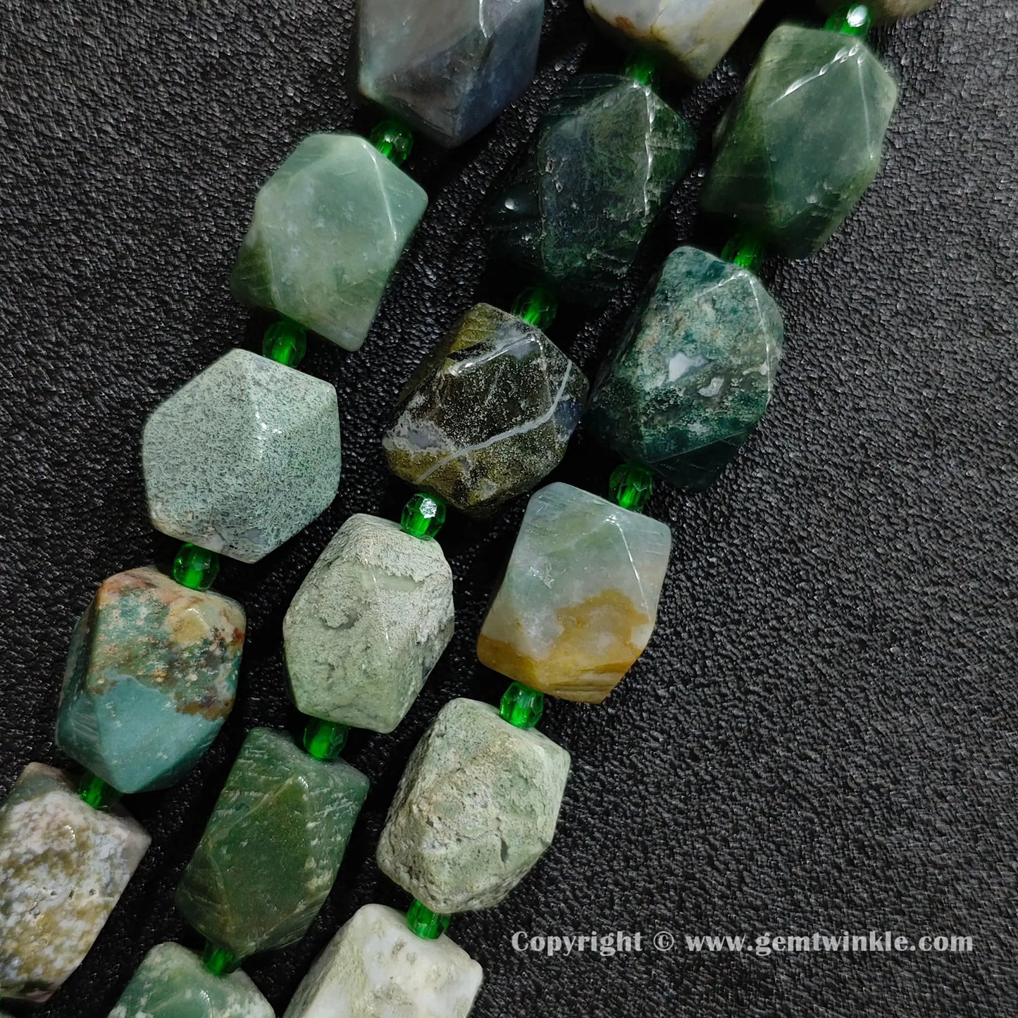 close up of orbicular green ocean jasper faceted cylinder stone